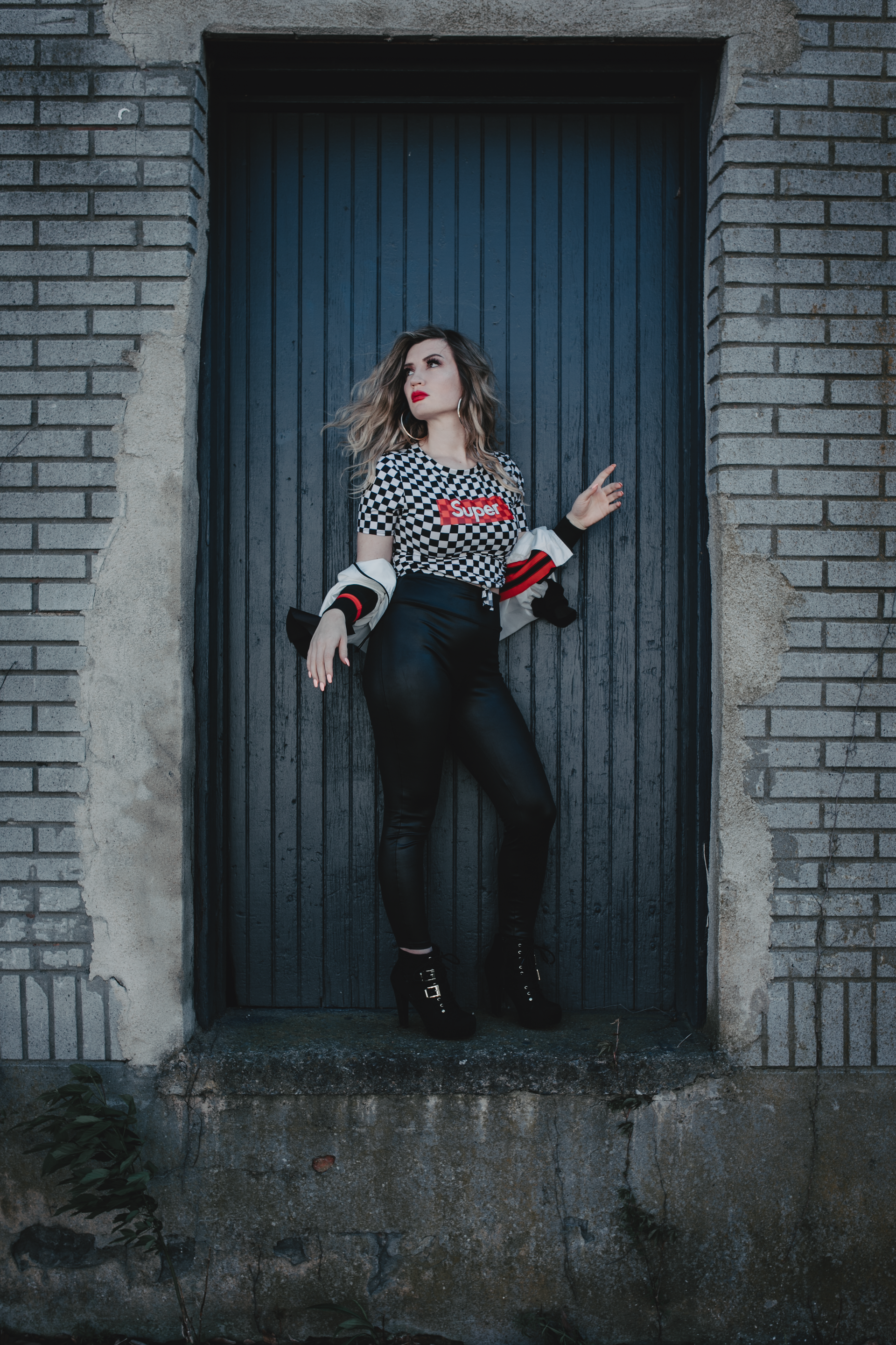 Model wearing black pants and checkered top