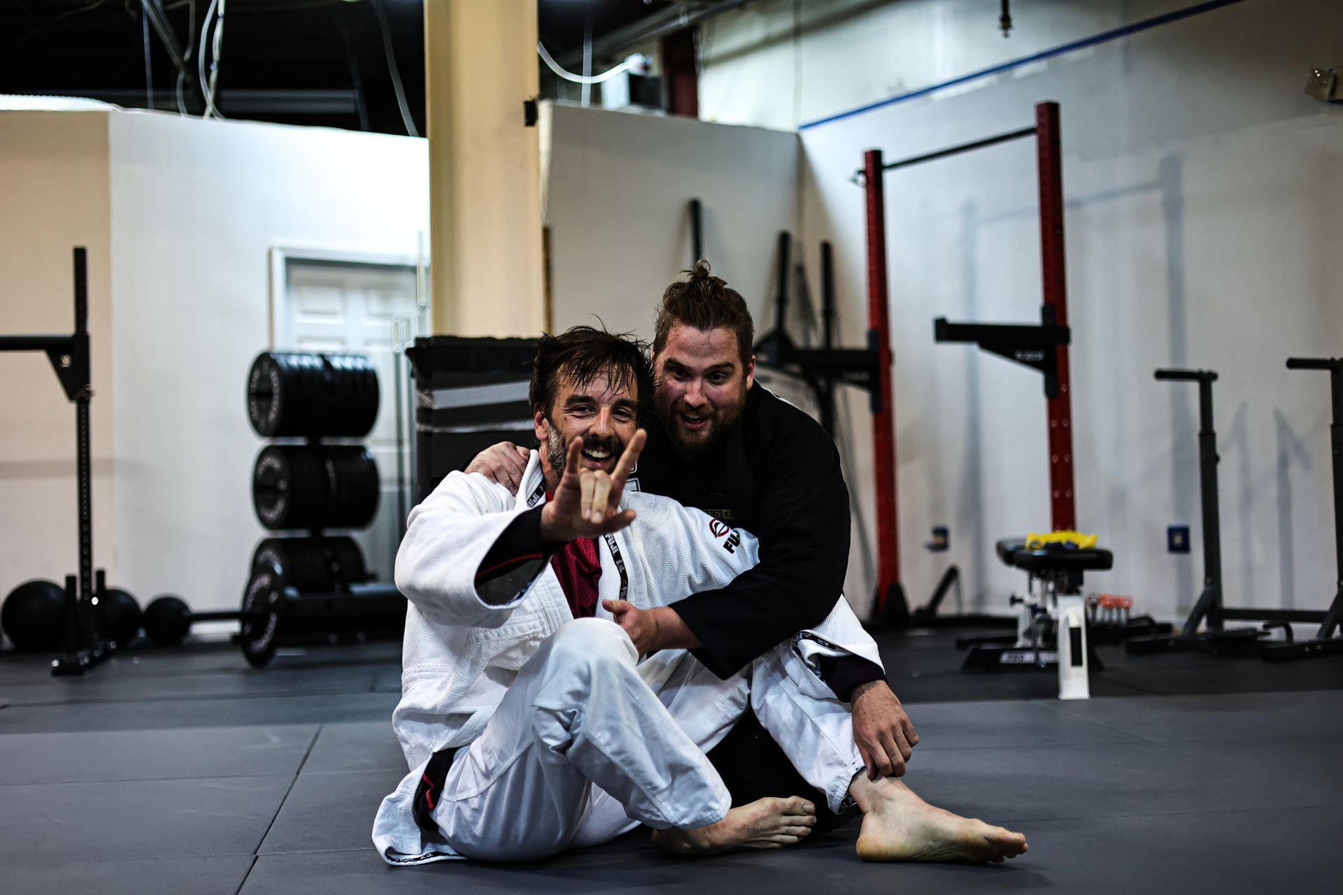 Adults practicing grappling in a Jiu-Jitsu class at Infinity Jiu-jitsu and Judo in Timonium, MD.