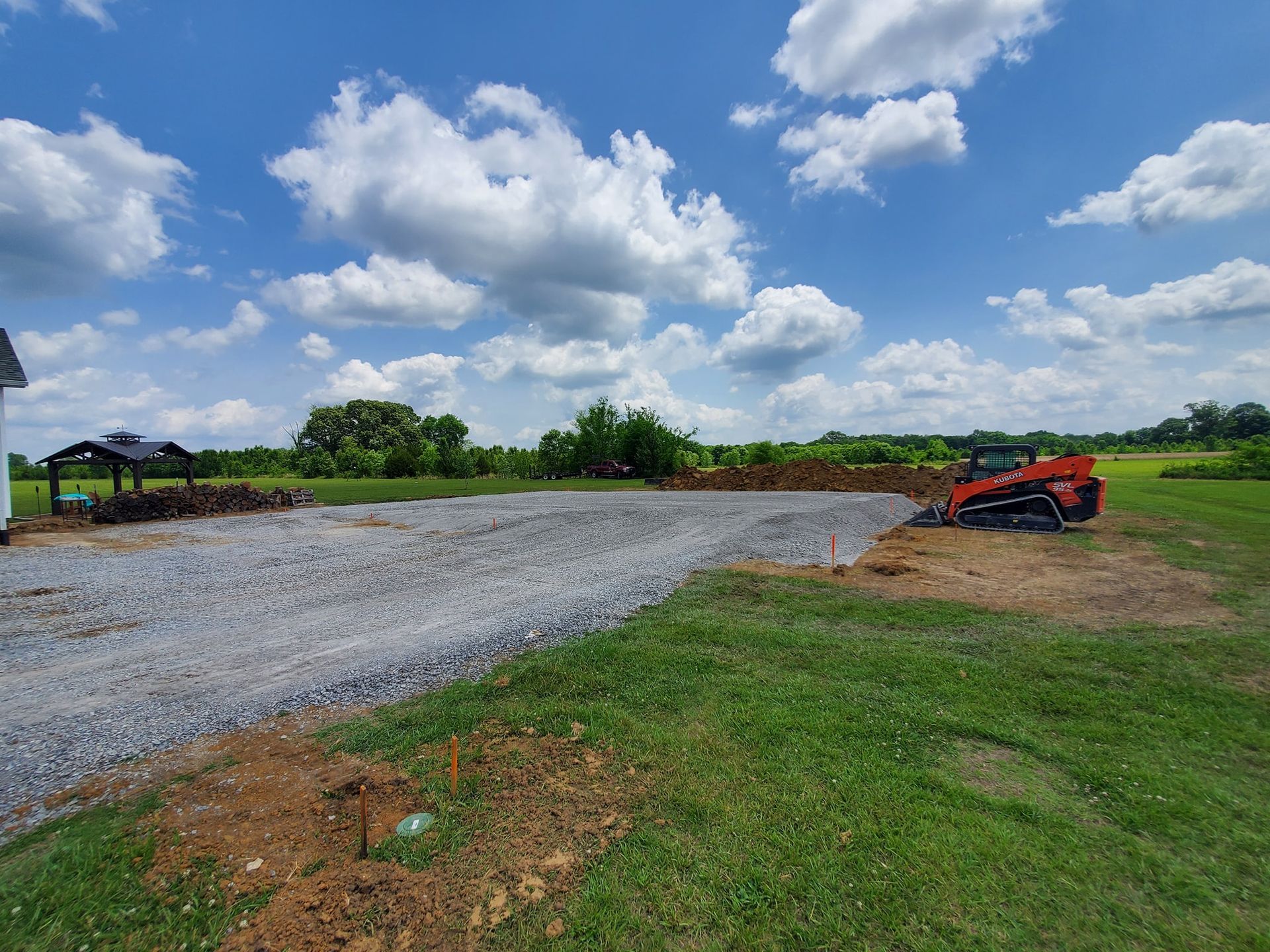 A bulldozer is sitting in the middle of a grassy field.