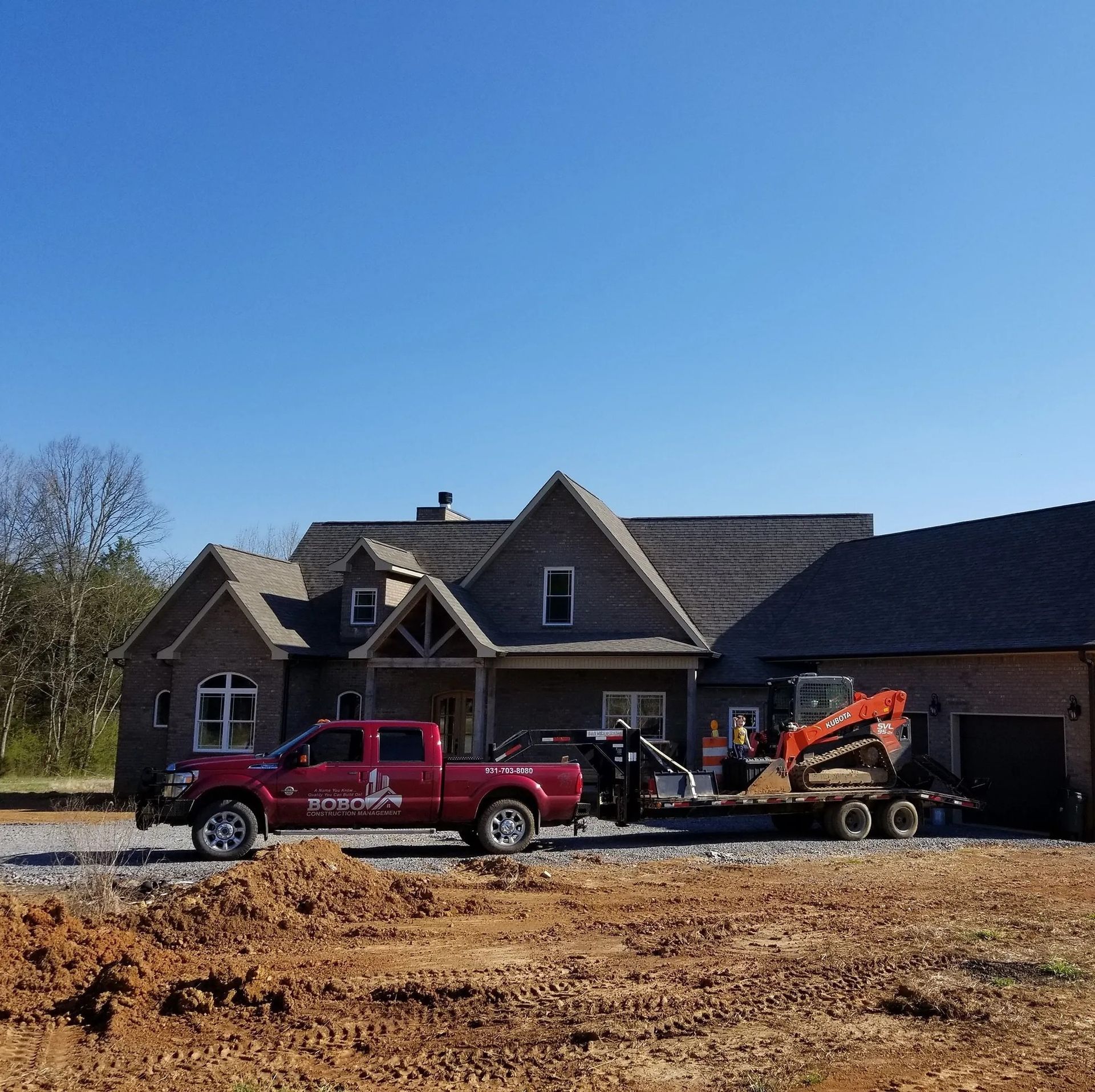 A red truck is parked in front of a house