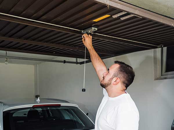 Man Opening The Garage Doors — Jacksonville, FL — Associated Doors
