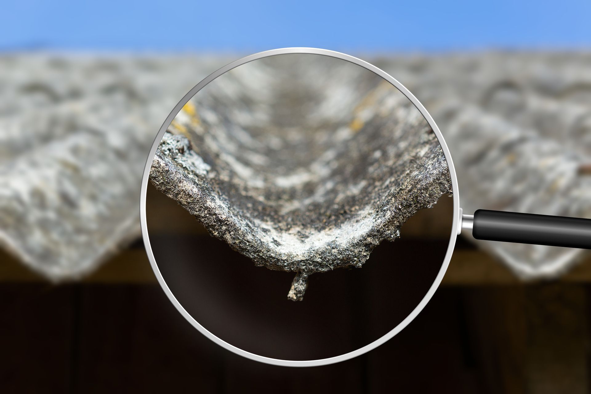 An old and very dangerous asbestos roof viewed through a magnifying glass.