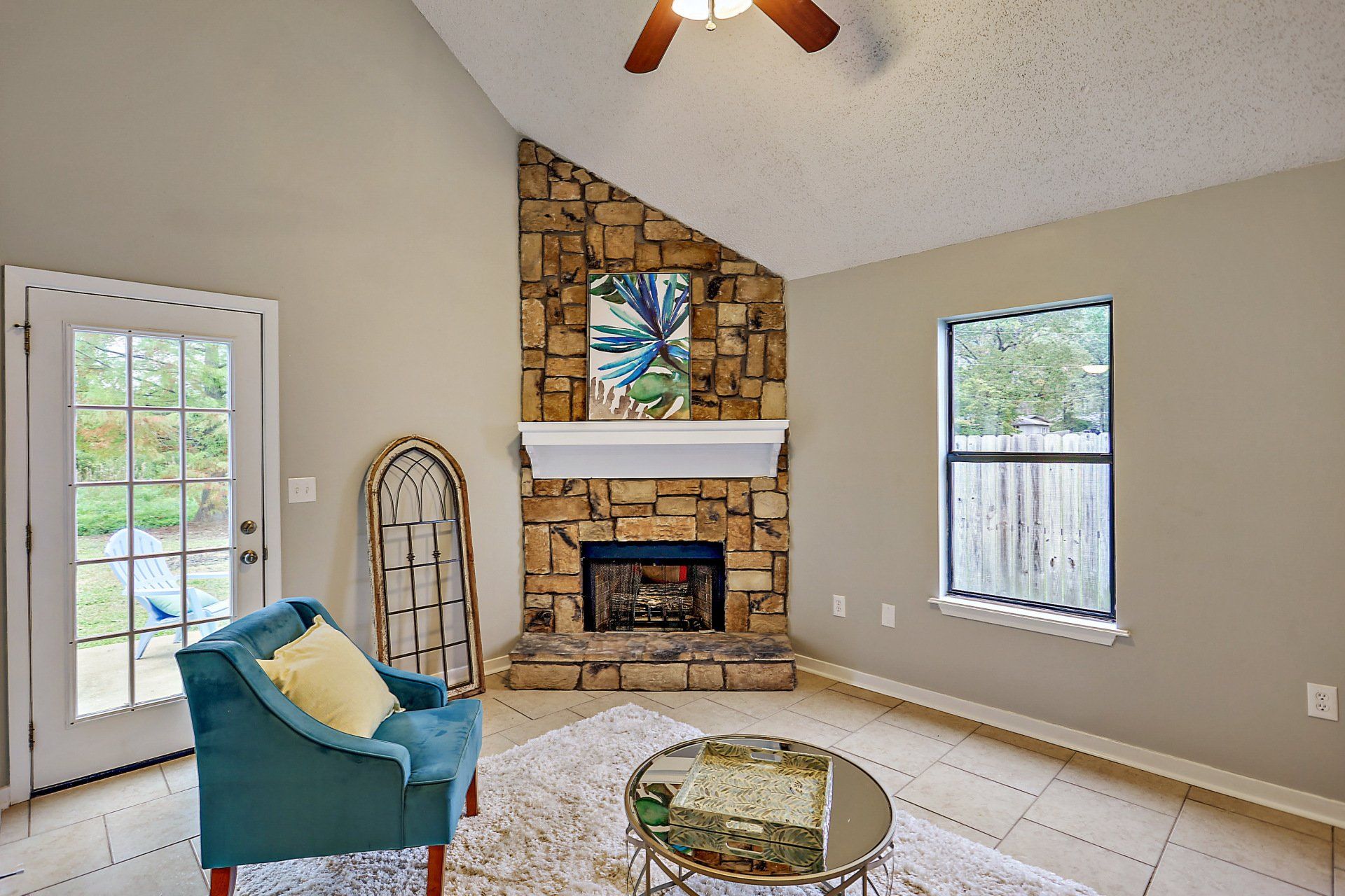 Living room with fire place and fan ceiling