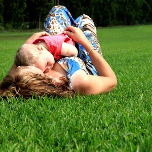 Mother and Child Lying Outdoors — Sydney NSW — Aussie Turf & Soil