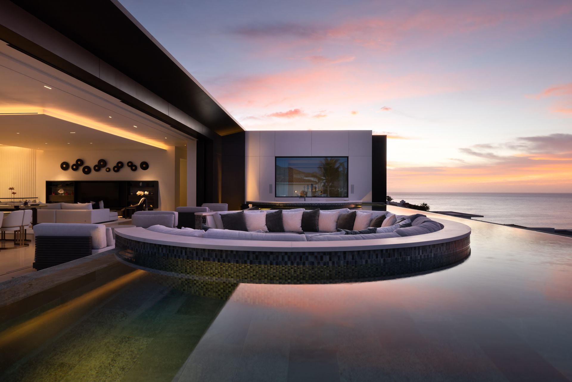 a large house with a lot of windows is sitting on top of a hill .