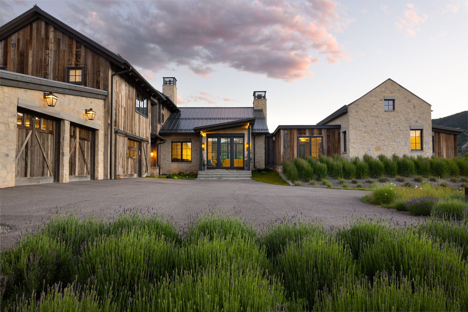 a large house with a lot of windows is sitting on top of a hill .