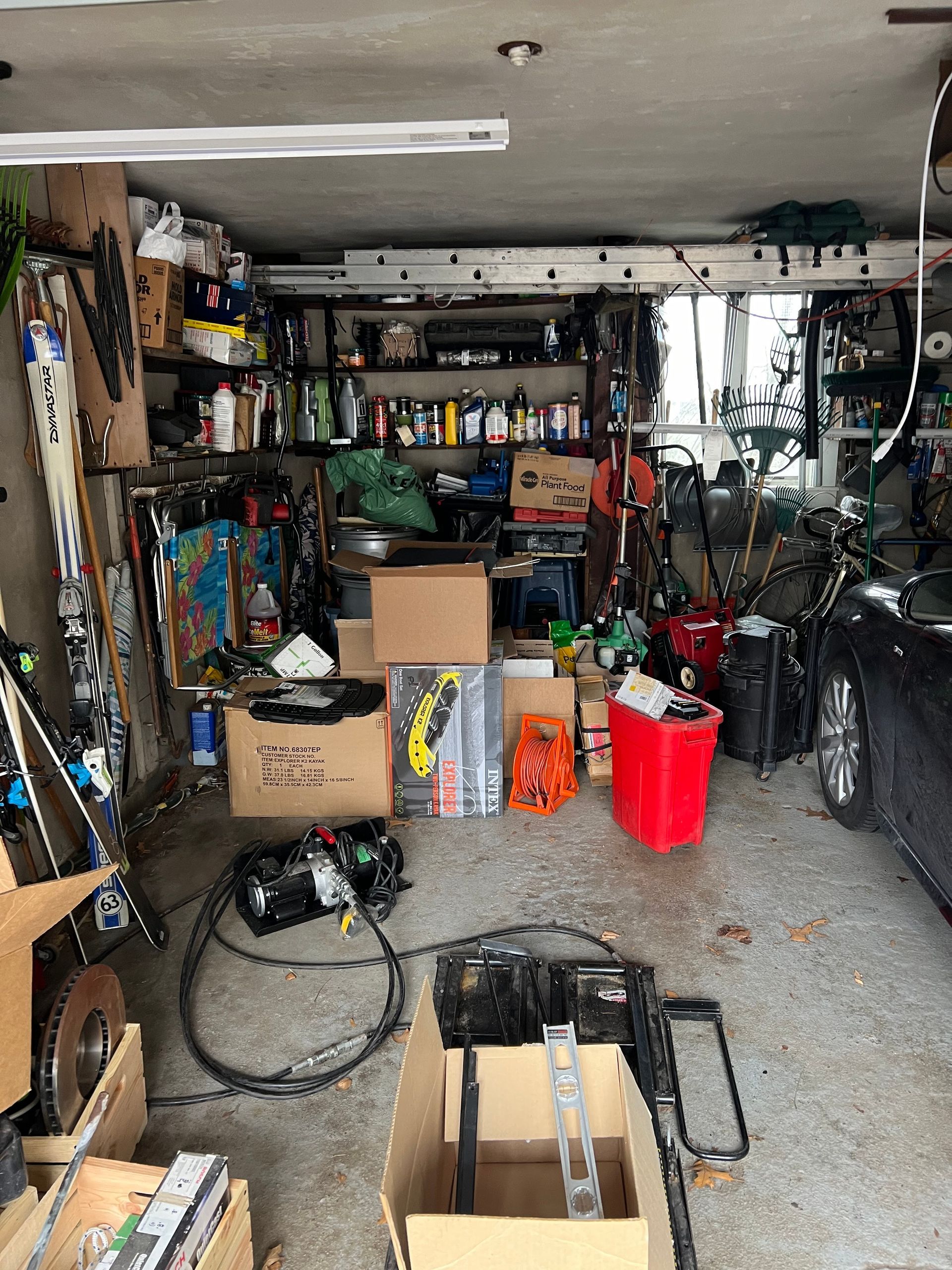 A garage filled with lots of boxes and tools.