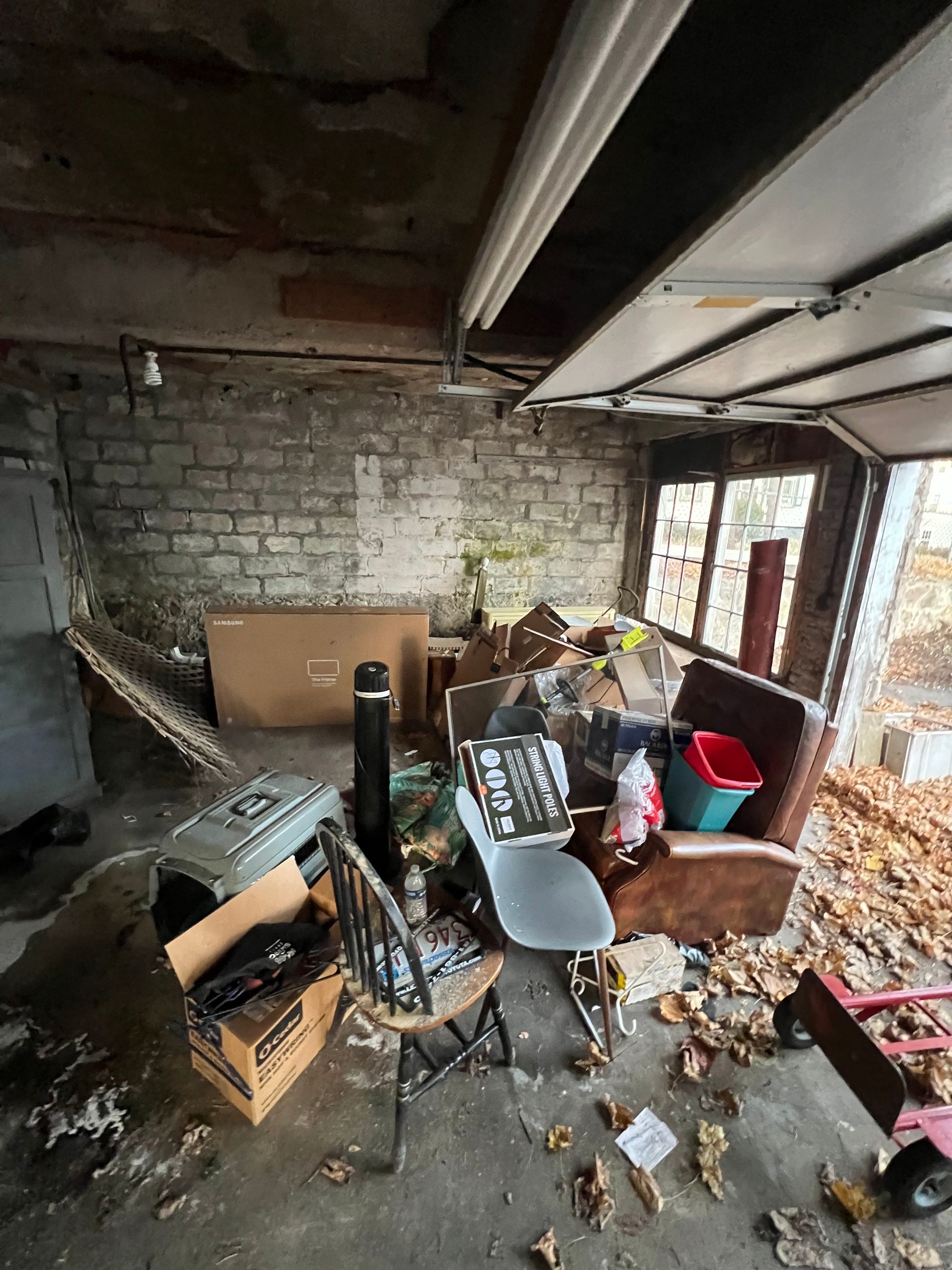A garage filled with lots of furniture and boxes.