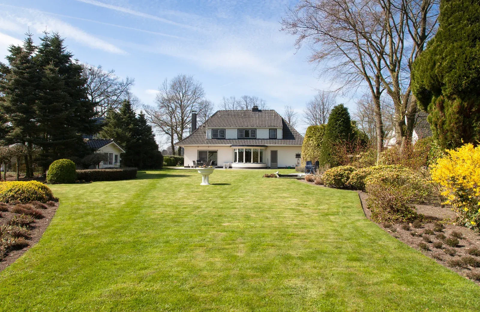 A large house with a lush green lawn in front of it