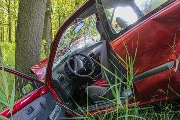 A vehicle is crashed into a tree.