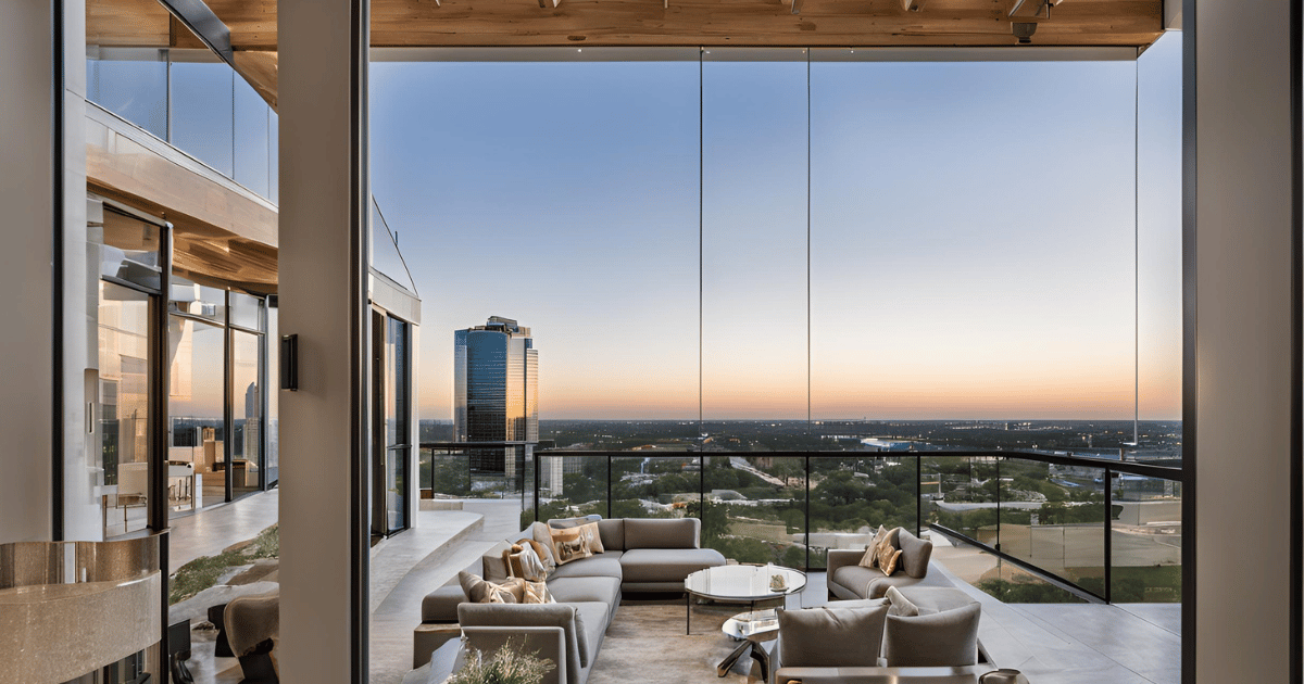 A living room with a balcony and a view of the city.