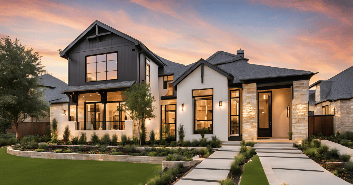 A large house with a lot of windows is sitting on top of a lush green lawn.
