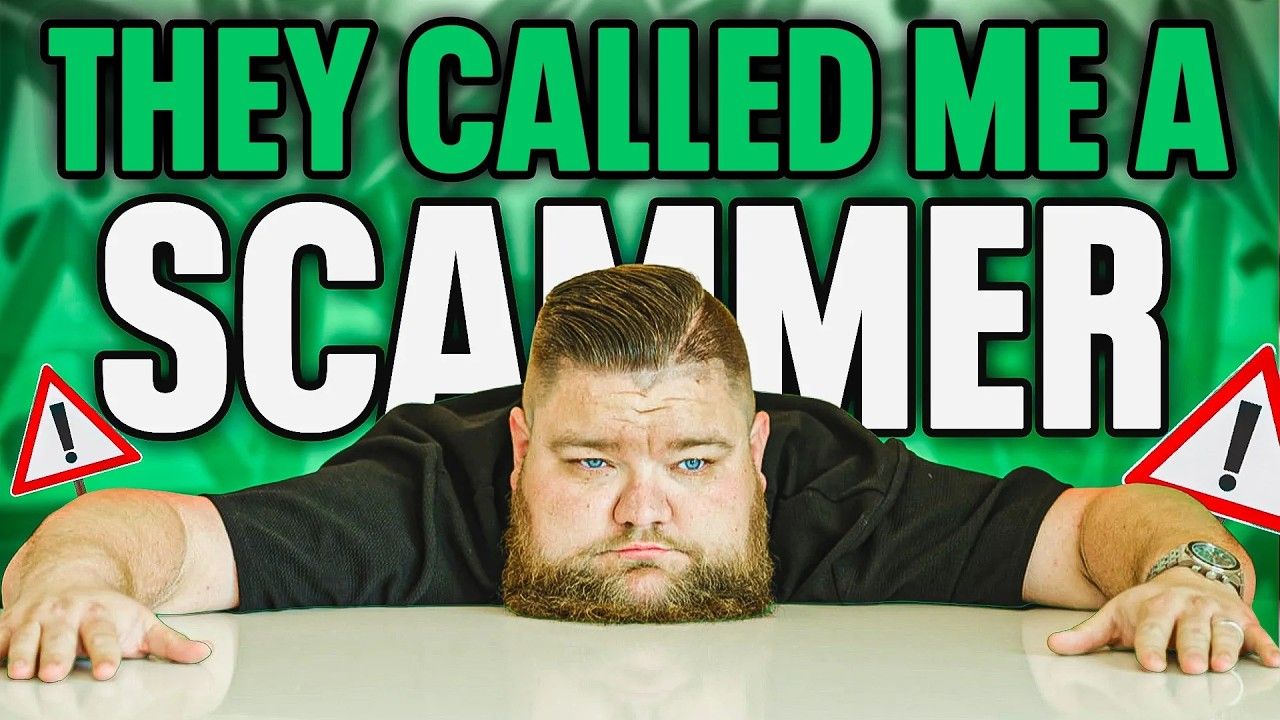 A man with a beard is laying on a table with a sign that says they called me a scammer.