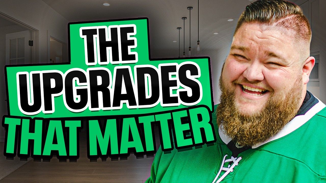 A man with a beard is smiling in front of a sign that says `` the upgrades that matter ''.