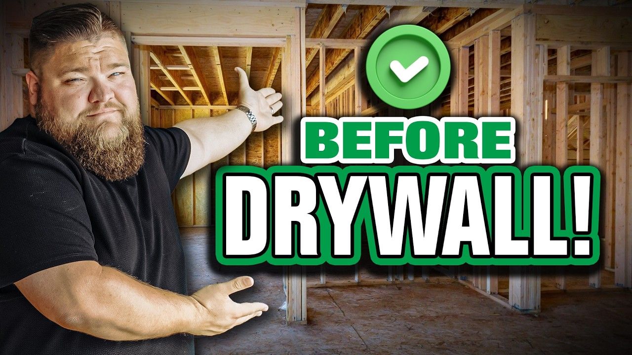Man gesturing at unfinished room with green check icon and text “BEFORE DRYWALL!”