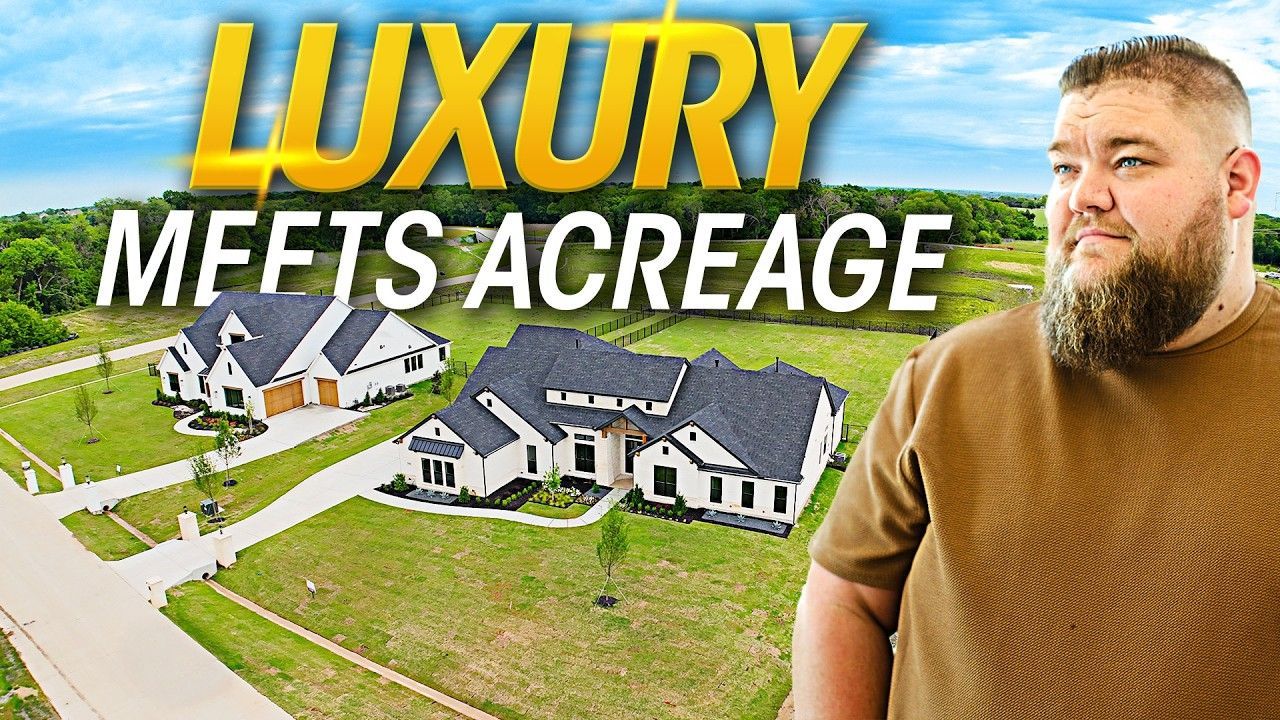 A man with a beard is standing in front of a house.