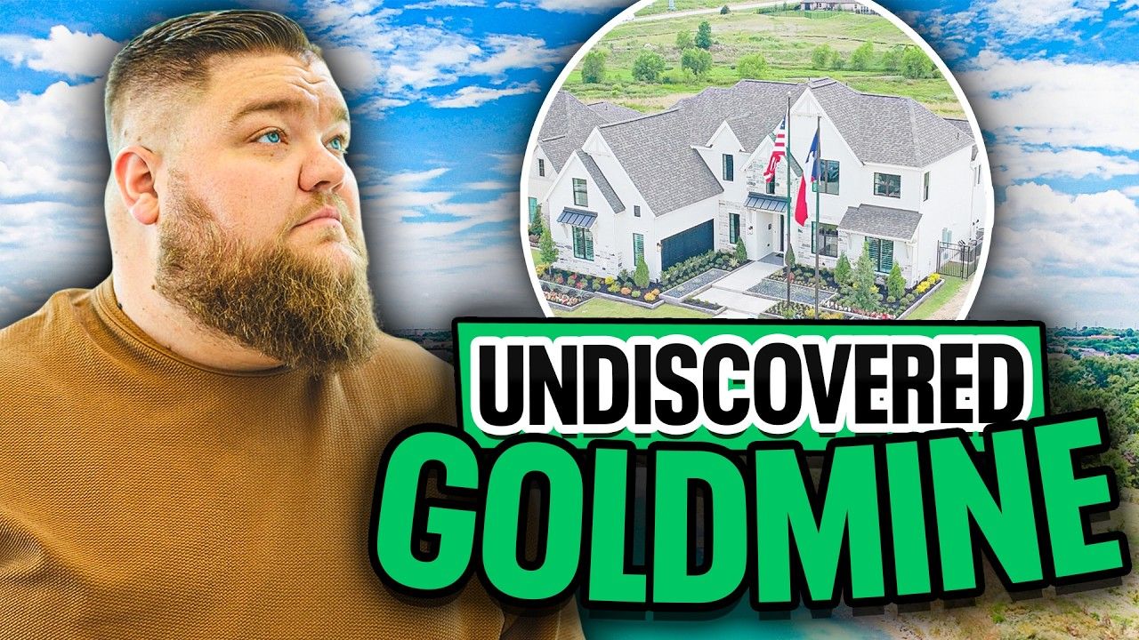 A man with a beard is standing in front of a house.
