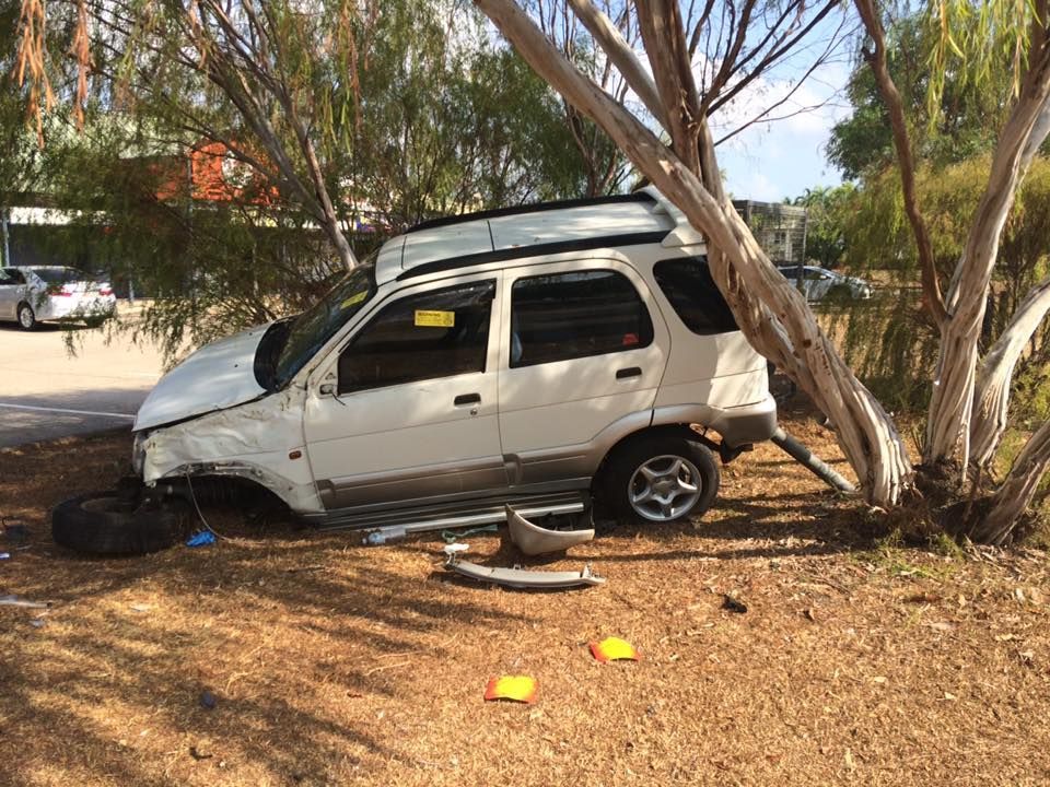 White SUV on a tow truck, driving on a road, under a cloudy sky — Banjo's Anytime Towing in Humpty Doo, NT