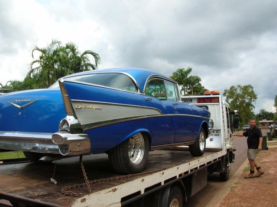 Blue Classic Car on a Tow Truck, Man Standing Nearby — Banjo's Anytime Towing in Darwin, NT