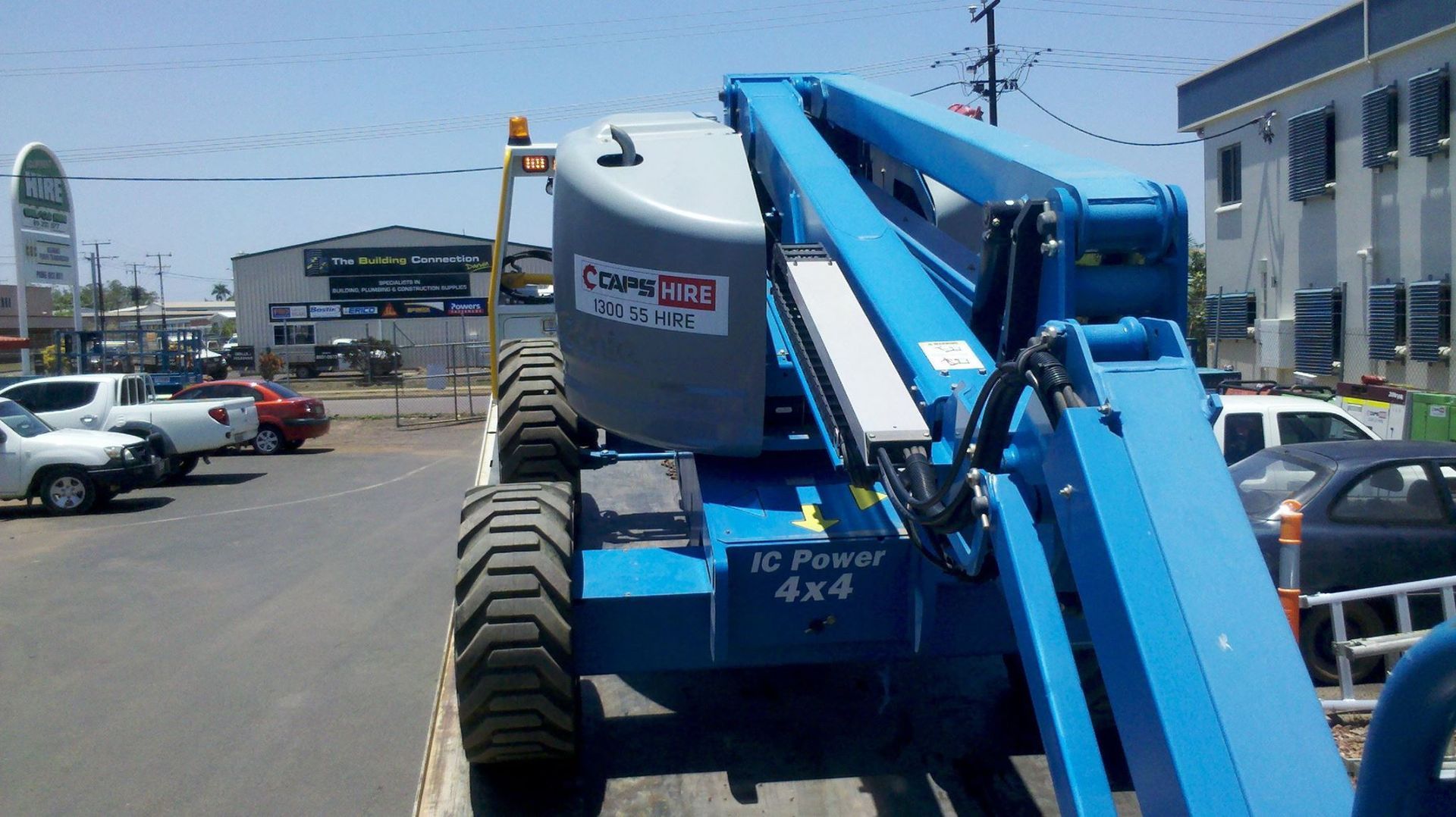 Blue Genie Lift on Asphalt, Near Parked Vehicles — Banjo's Anytime Towing in Darwin, NT