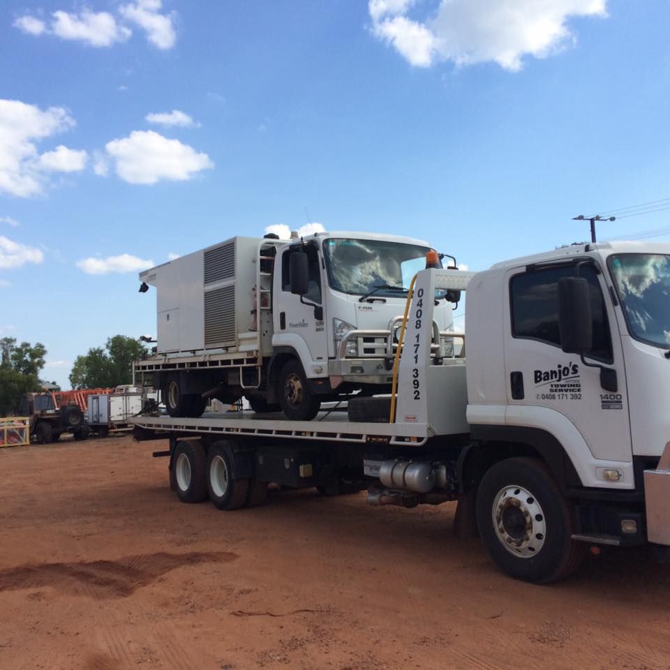 White Truck Carrying a Generator on a Flatbed Trailer — Banjo's Anytime Towing in Humpty Doo, NT