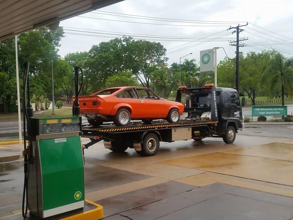 Orange Sports Car on Tow Truck at a Bp Gas Station — Banjo's Anytime Towing in Casuarina, NT