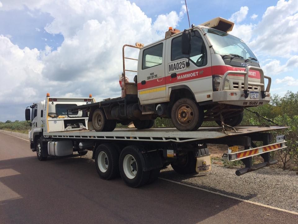 A White Tow Truck Carrying a Smaller White Truck — Banjo's Anytime Towing in Palmerston, NT