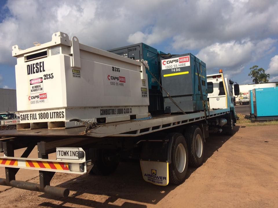 A Flatbed Truck Loaded With Equipment — Banjo's Anytime Towing in Humpty Doo, NT