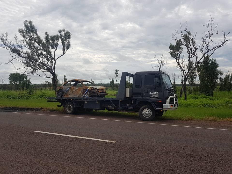 Tow Truck Carrying a Burnt-out Car — Banjo's Anytime Towing in Humpty Doo, NT