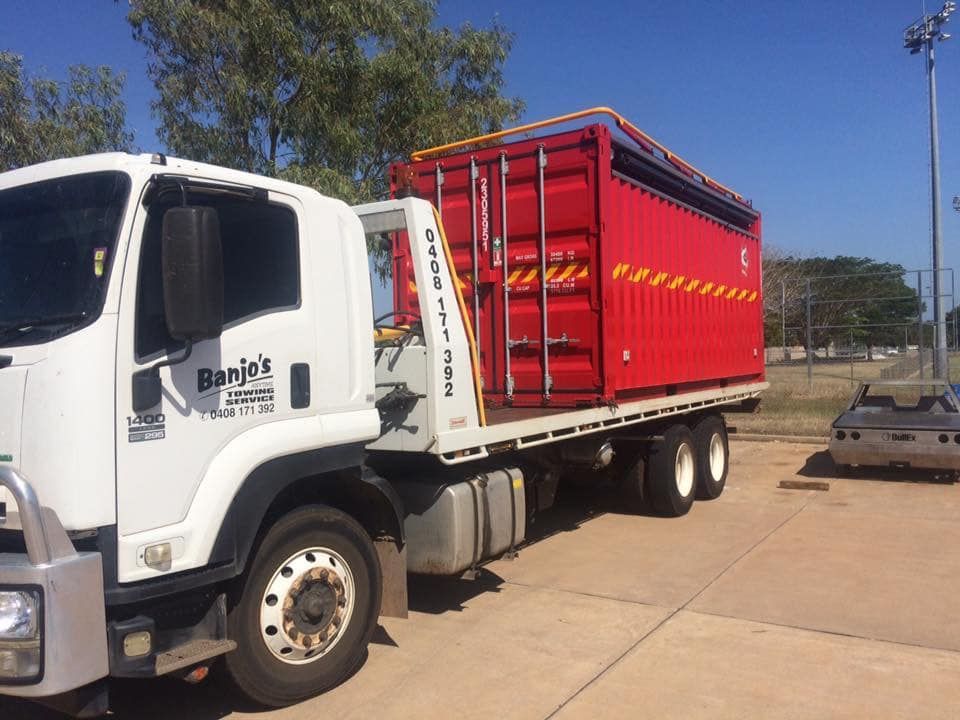White Truck With a Red Shipping Container on Its Flatbed; Outdoors — Banjo's Anytime Towing in Palmerston, NT