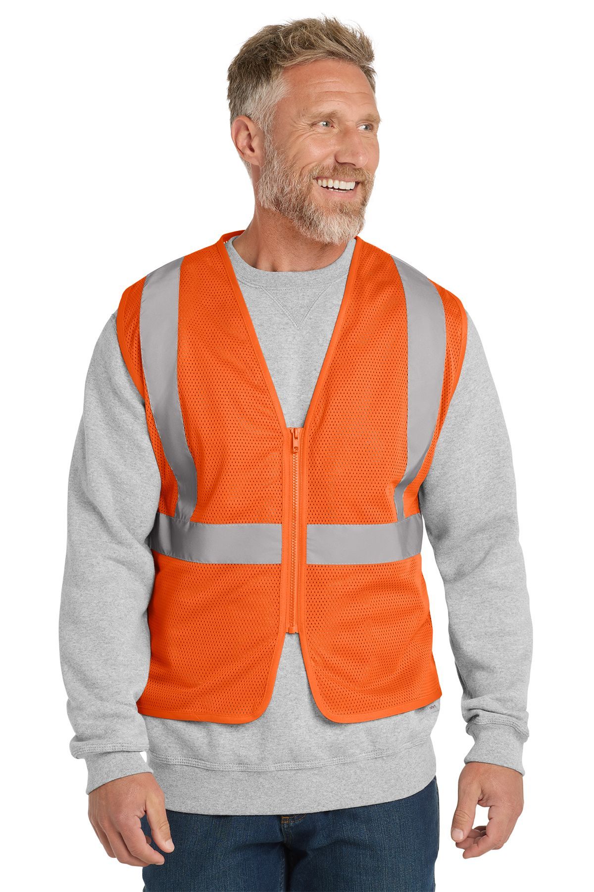 Man wearing an orange safety vest with reflective stripes over a gray sweatshirt, smiling.