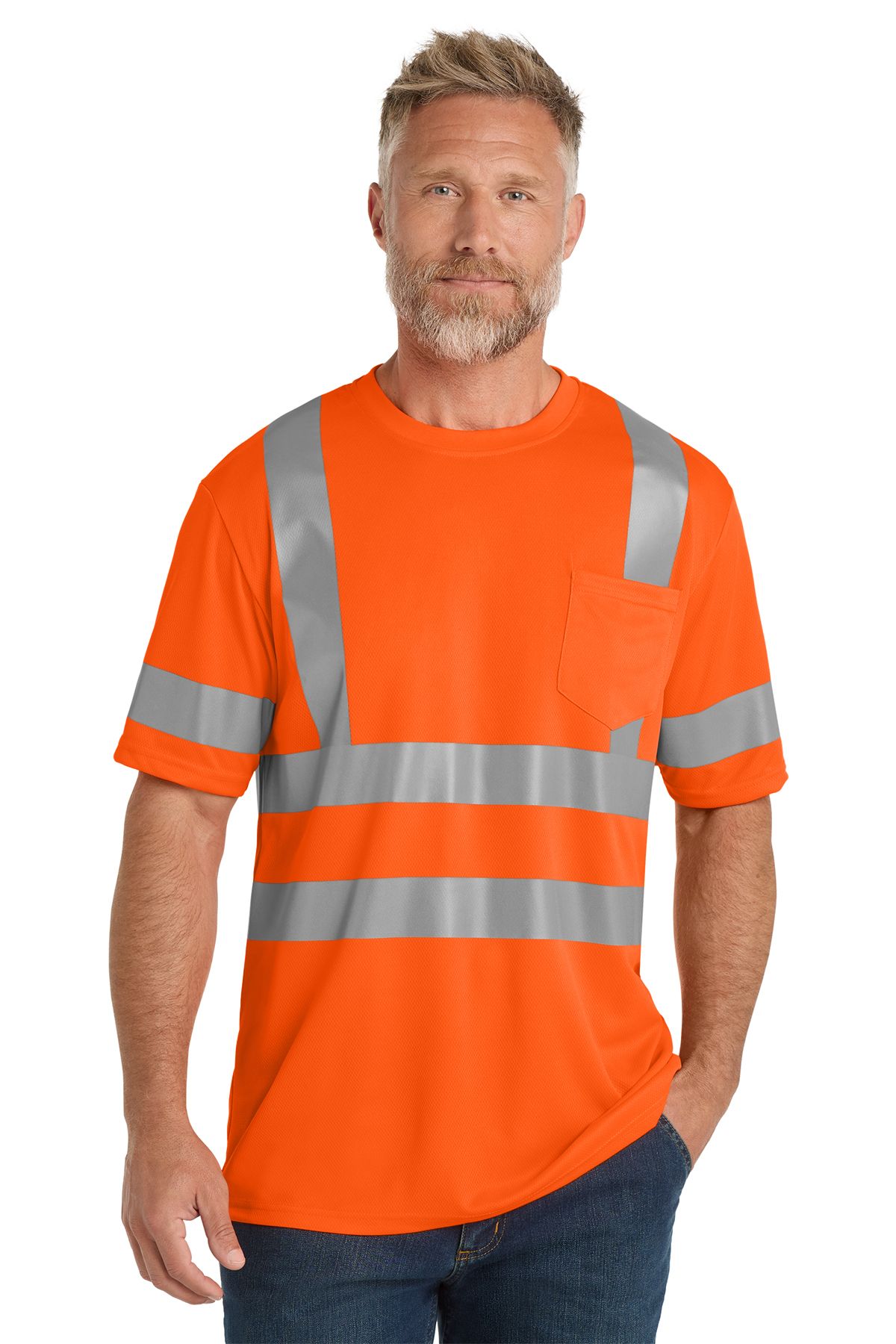 Man wearing a bright orange reflective safety t-shirt, standing with his hand in his pocket.