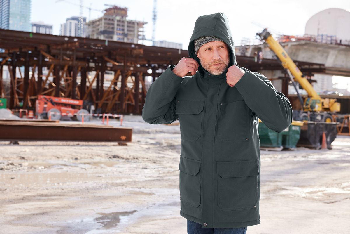 Worker wearing a thick heavy CornerStone Coat by PHA Gear for the Trades