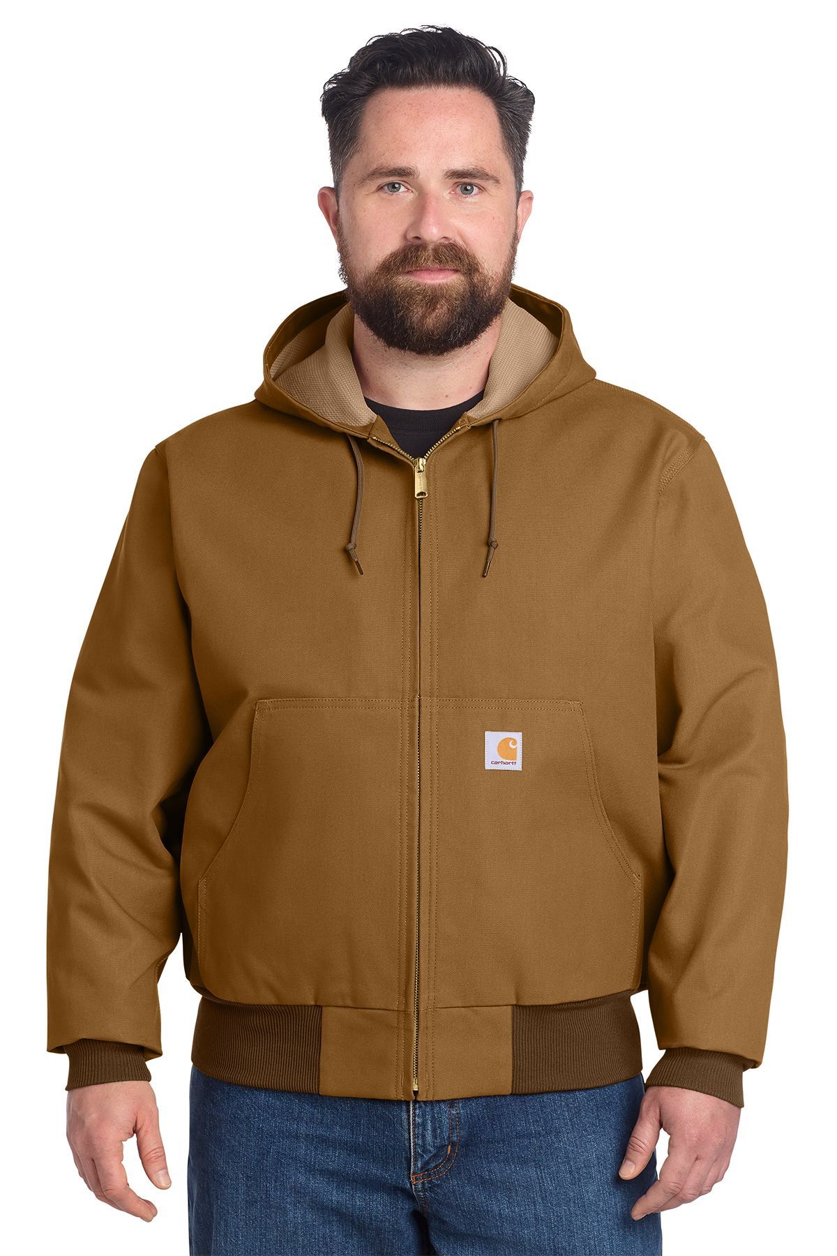 Man wearing a brown hooded Carhartt jacket, blue jeans, and looking forward.