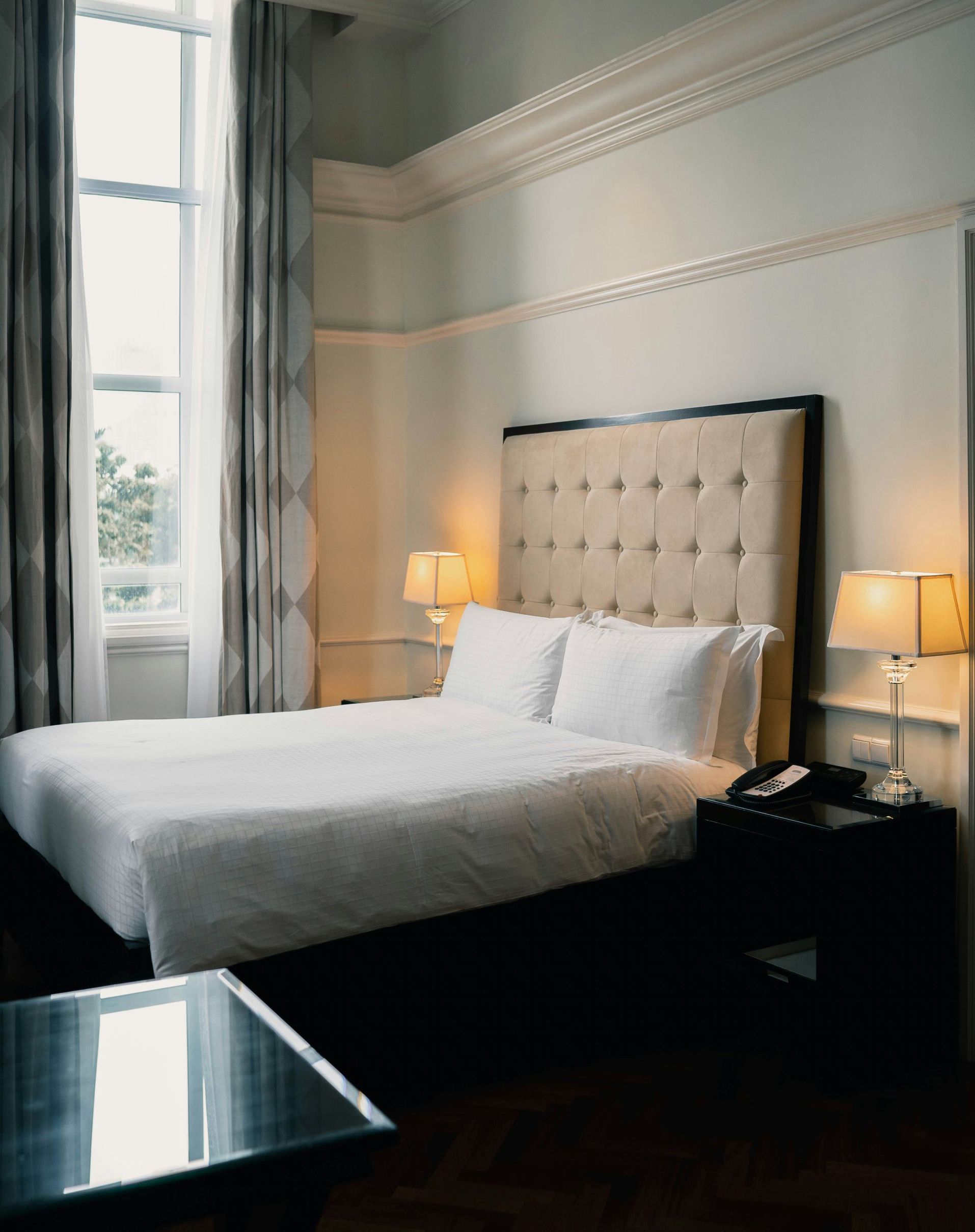 A woman is sleeping in a bed with a blanket and pillows.