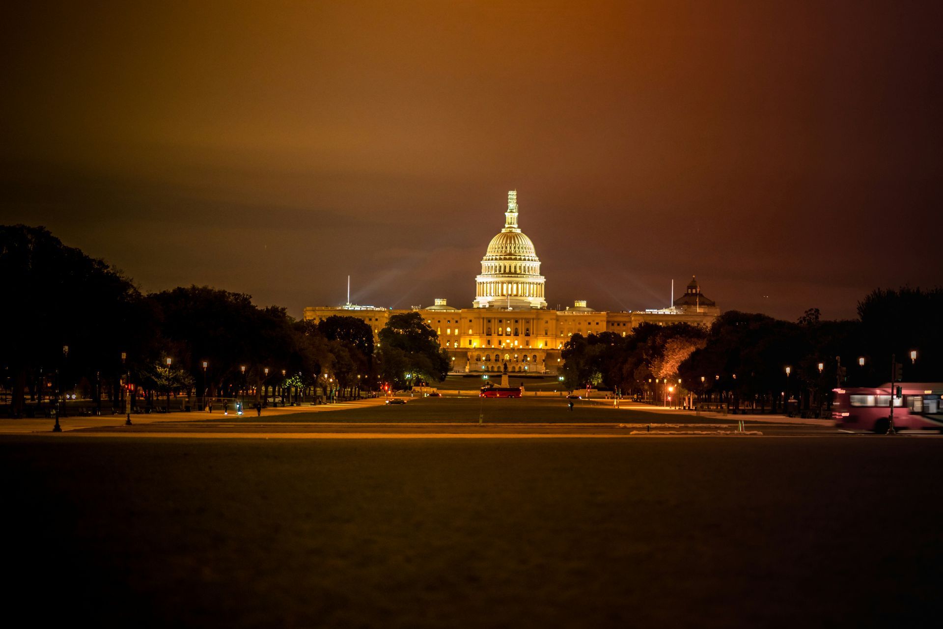The capitol building in washington d.c. is lit up at night.