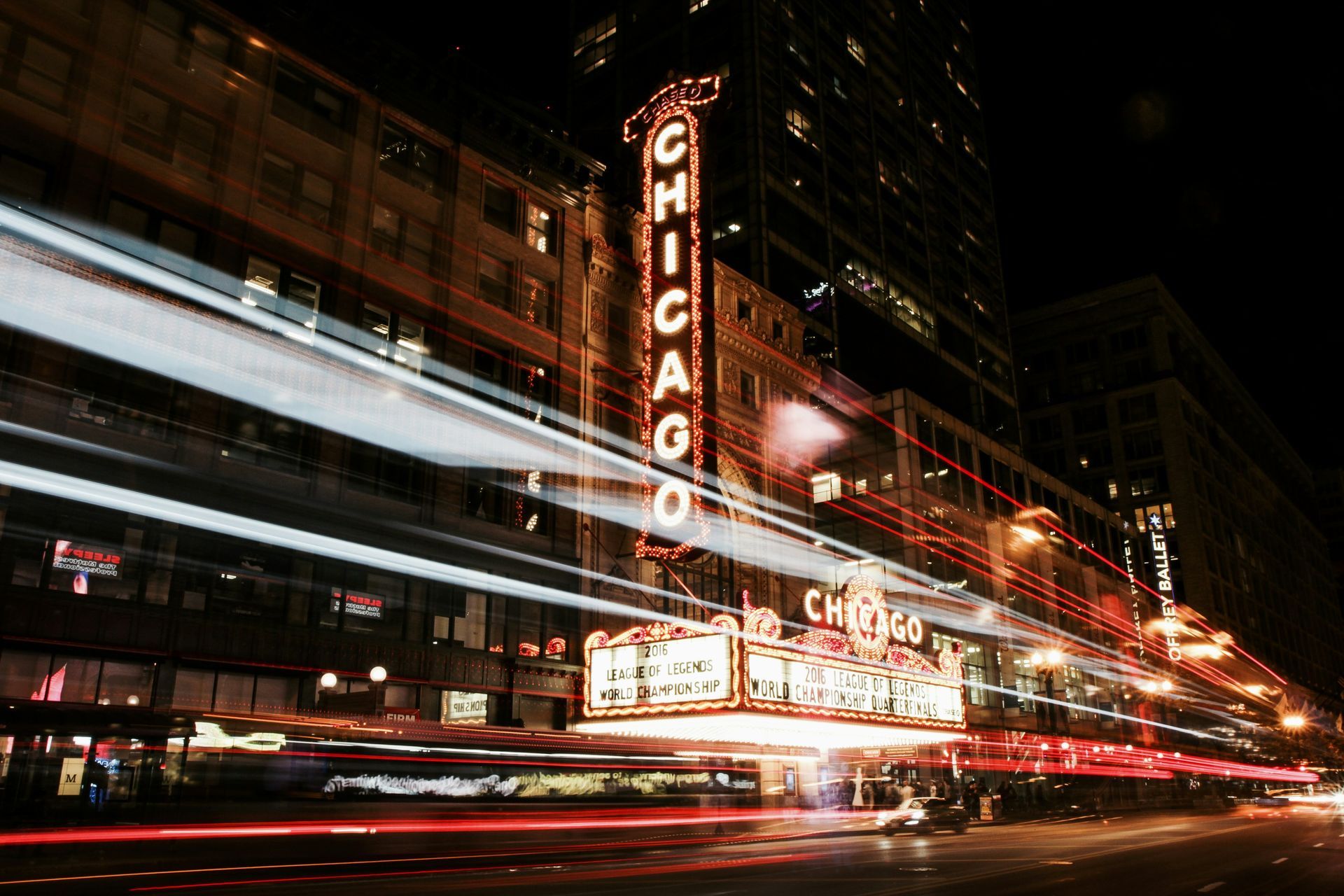 A long exposure photo of the Chicago theater at night.
