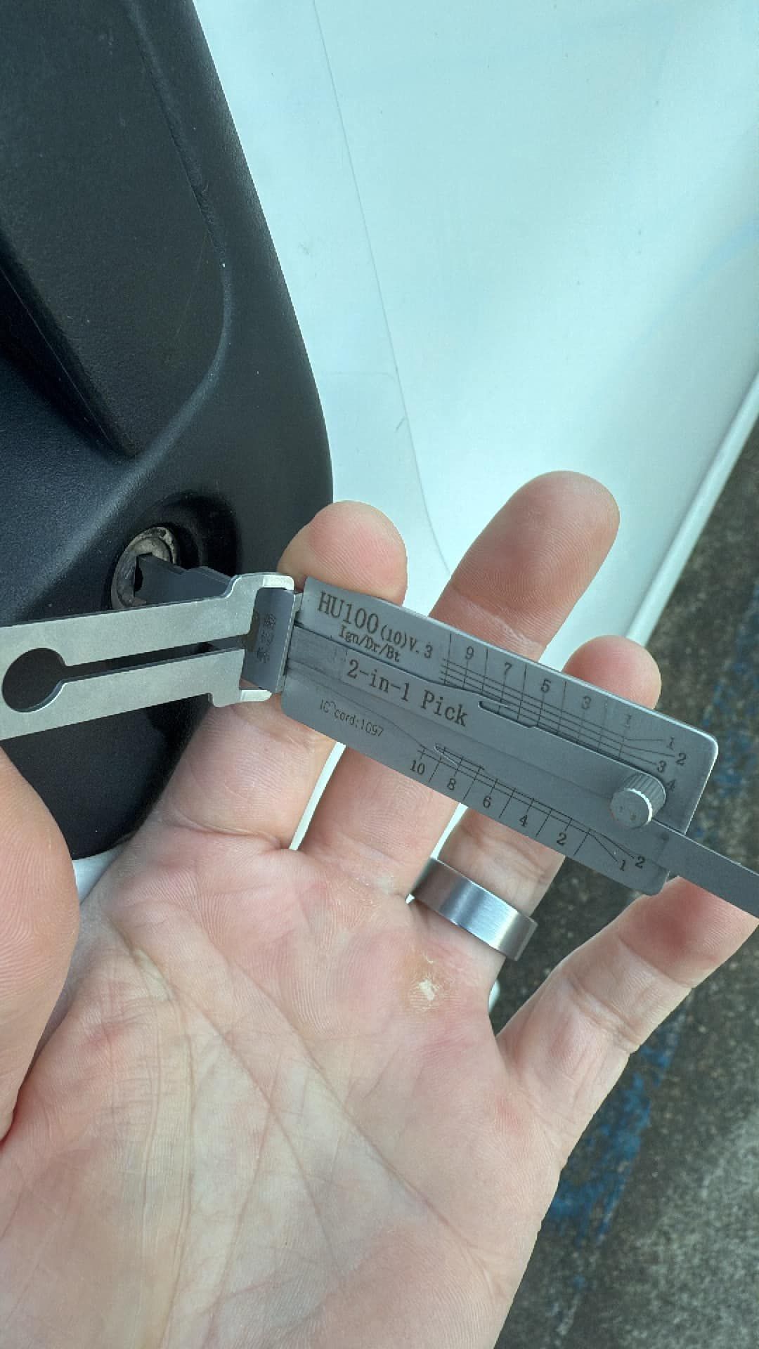 A person is holding a measuring device in their hand.