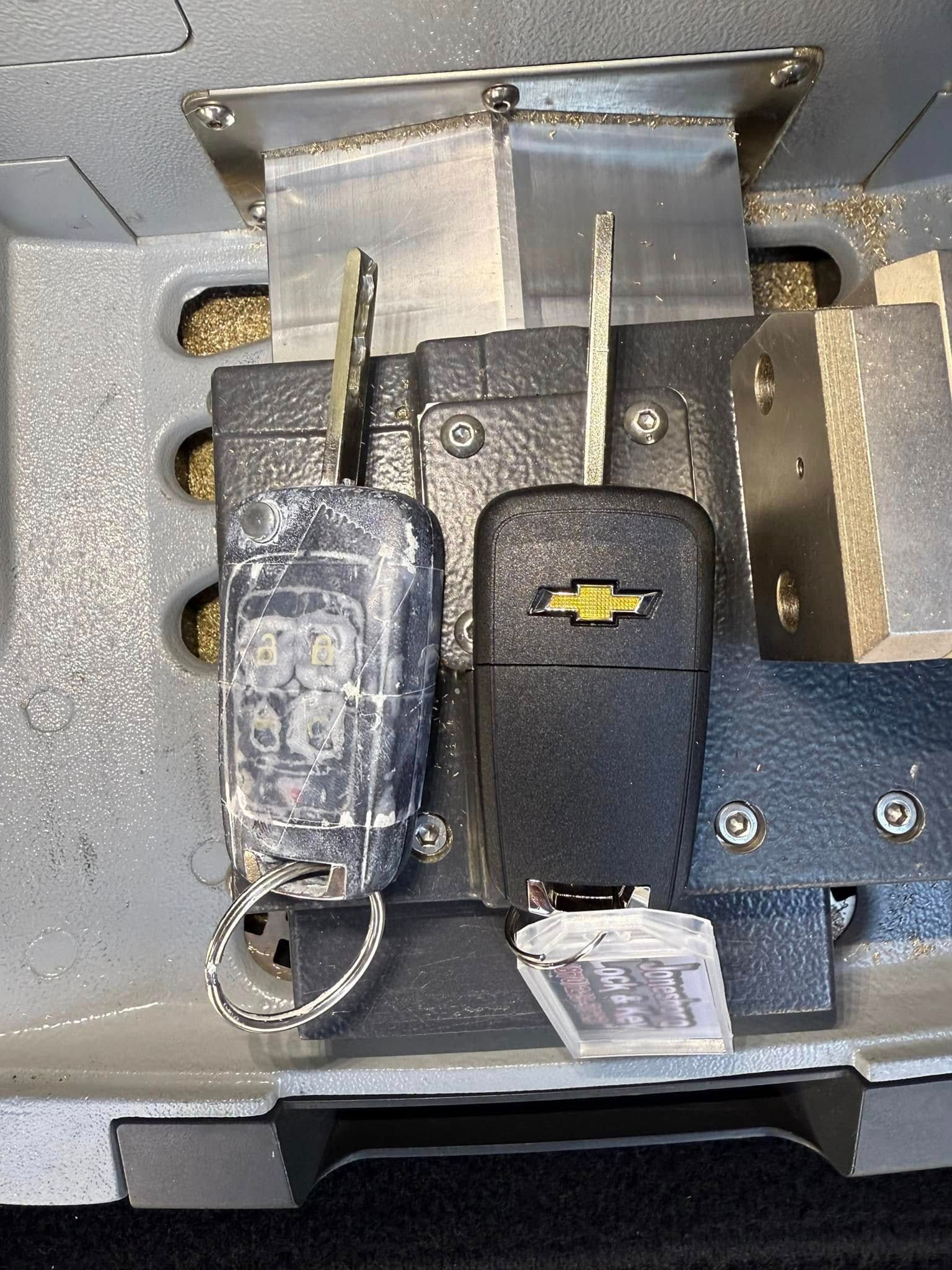 A car key is sitting on top of a machine.