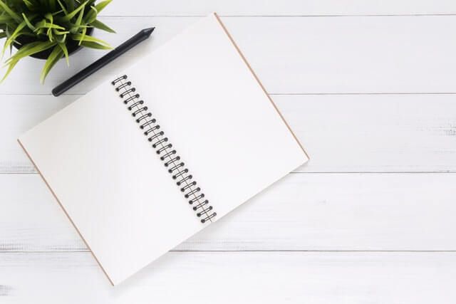 blank notebook with pen for ignoring SEO