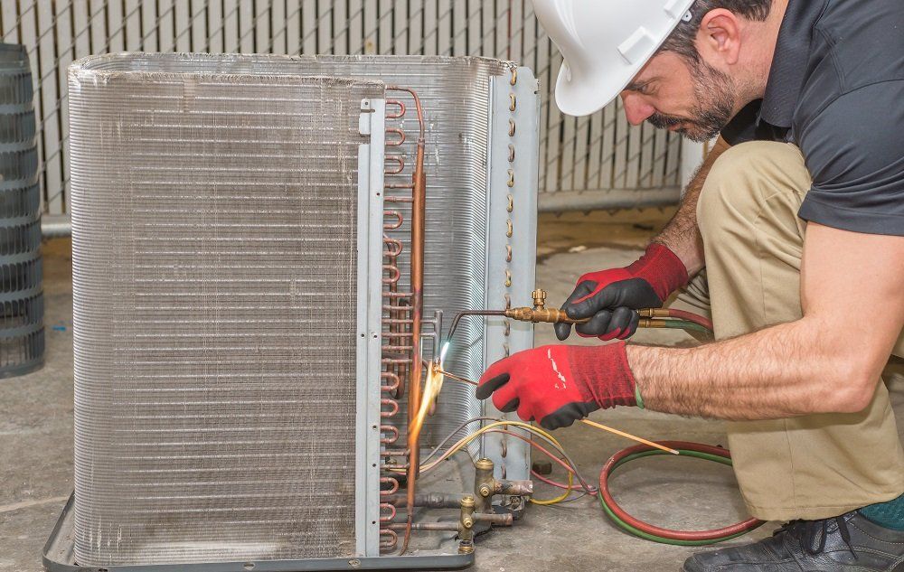 Heating and air conditioning inverters on the side of a condo