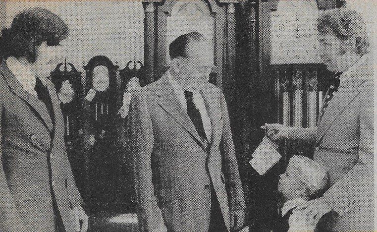 A black and white photo of three men in suits and ties