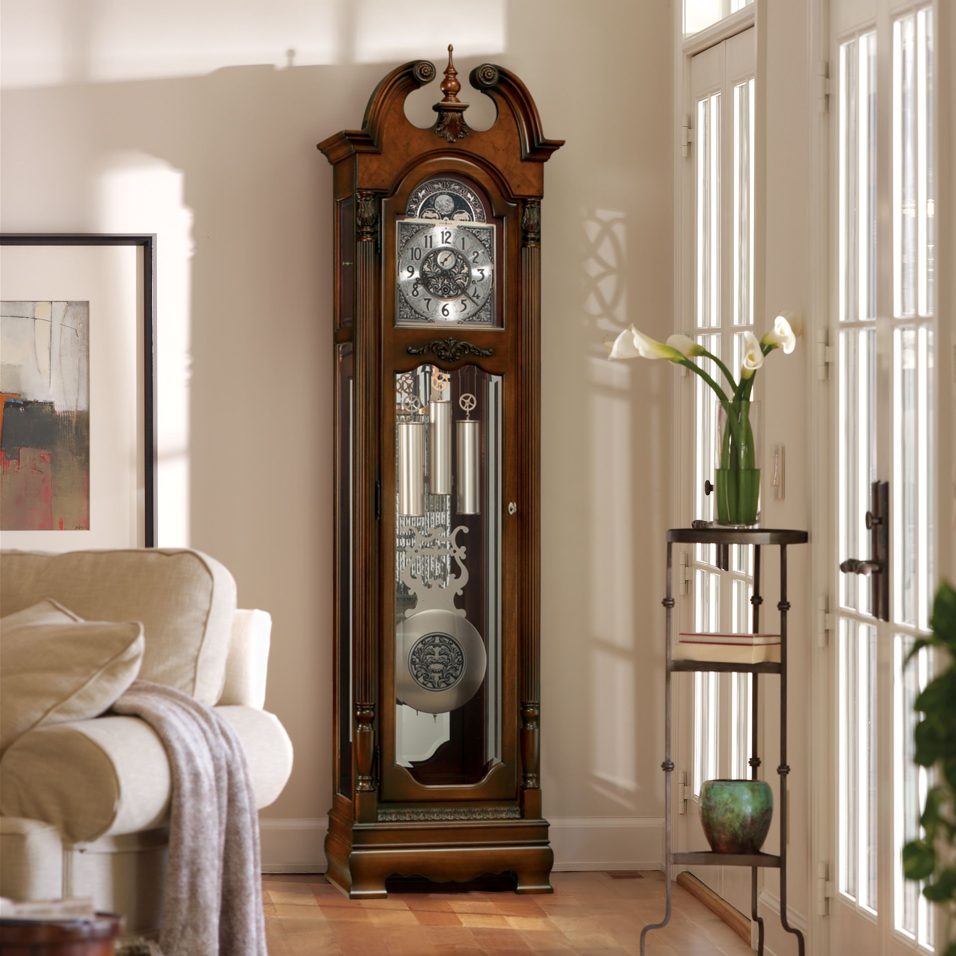 A living room with a grandfather clock and a couch
