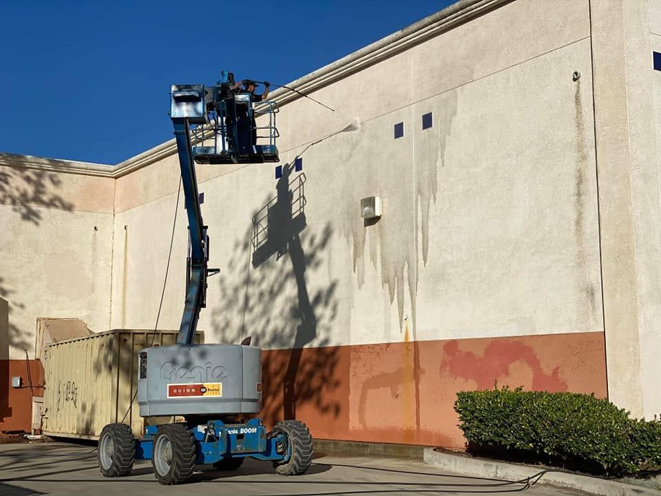 A machine is cleaning the side of a building