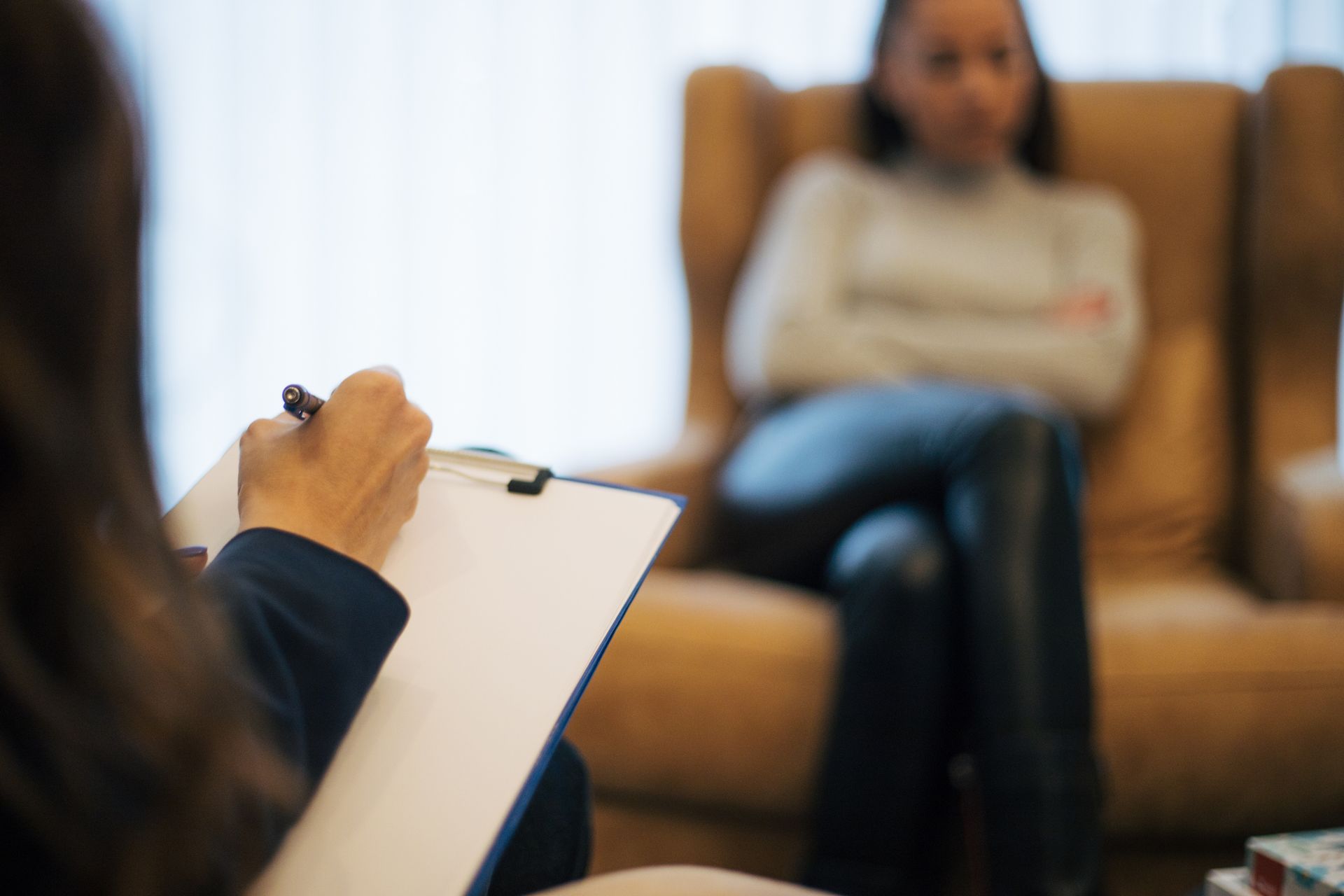 Woman discussing recovery goals in outpatient therapy.