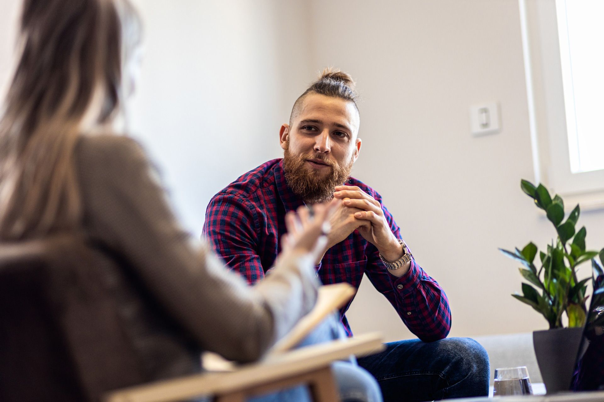 A man and a woman are sitting at a table talking to each other