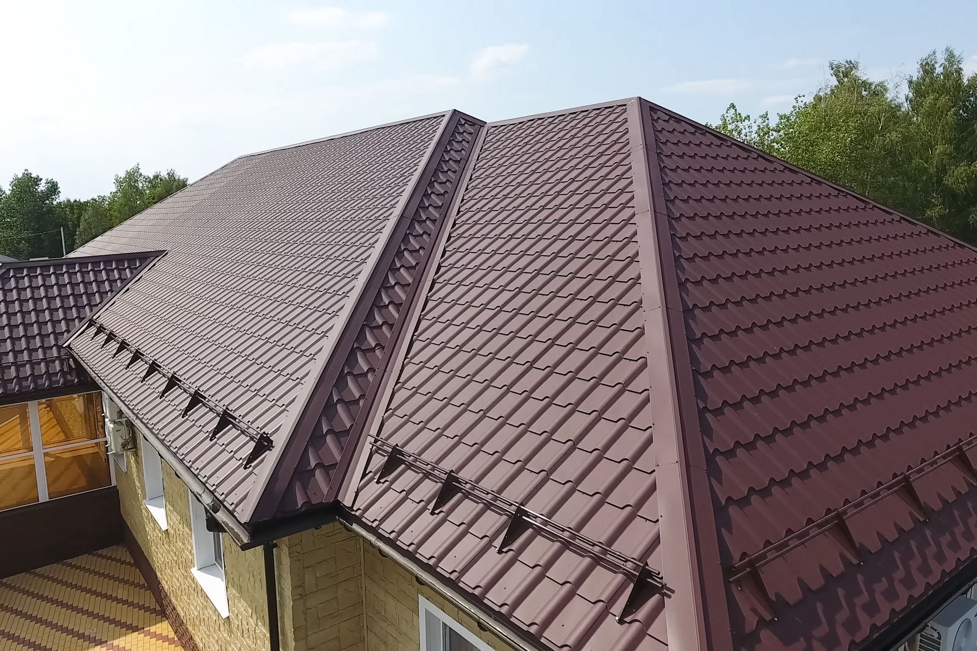 An aerial view of a house with a brown roof