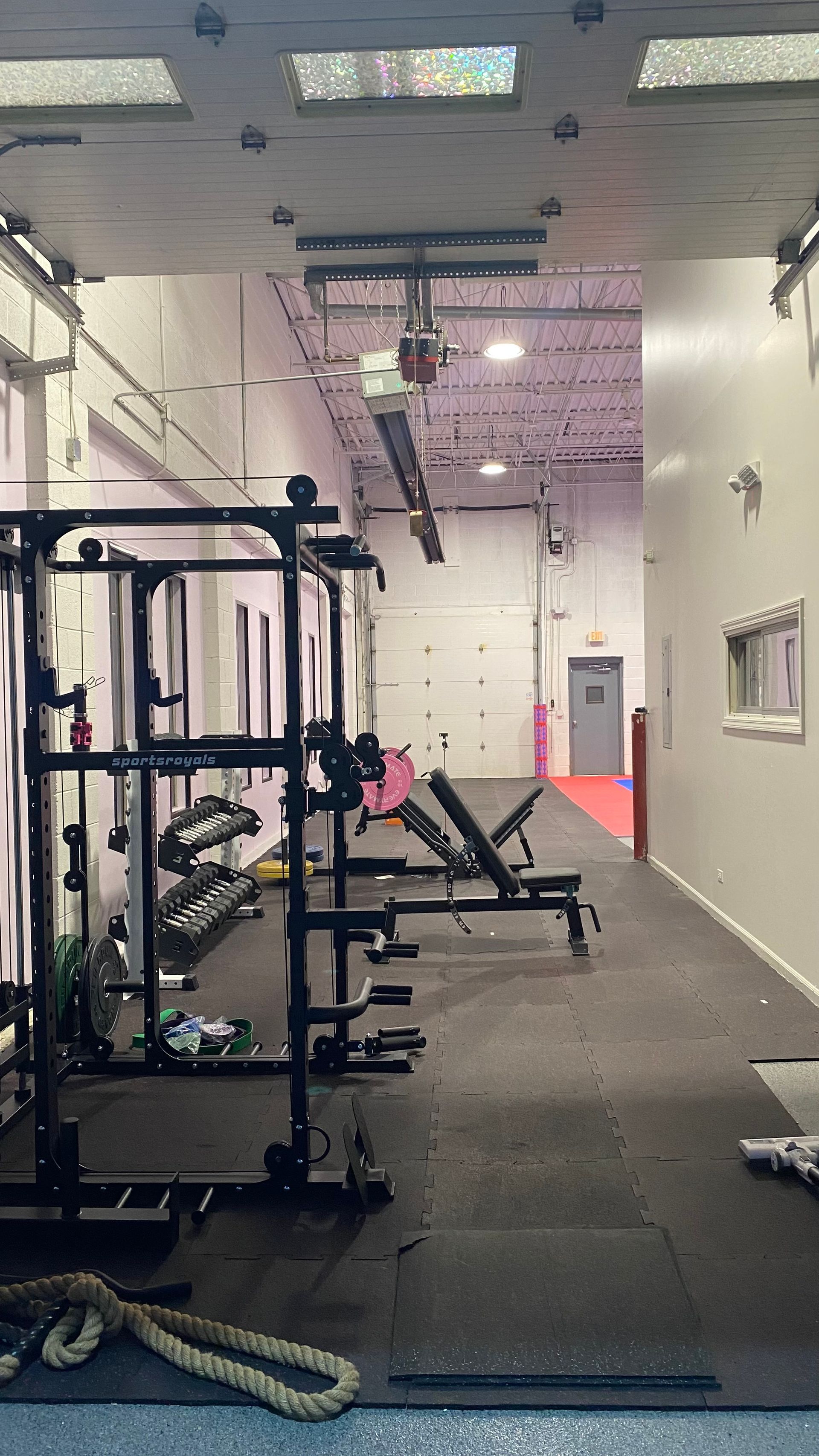 A gym with a lot of exercise equipment in it.