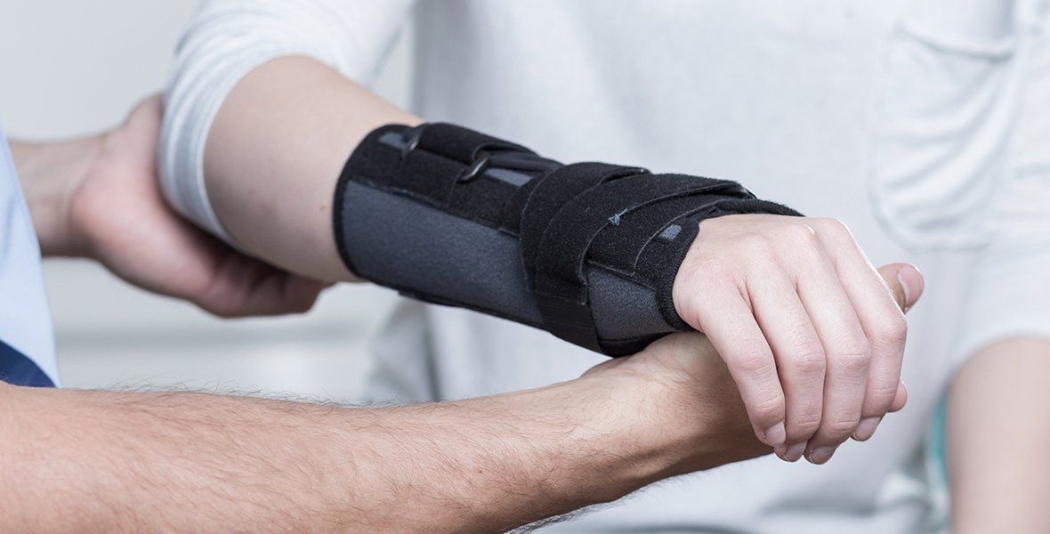 Person with Arm Bracing — DFW, TX — Texas Non-Surgical Orthopedic