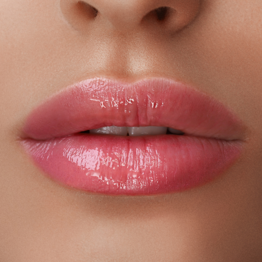 Eine Nahaufnahme der Lippen einer Frau mit rosa Lippenstift.